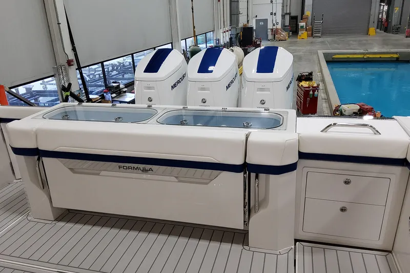 Slide: The Image of 2026 Formula 457 Center Console Fish boat with Mercury engines in a workshop setting. - 18