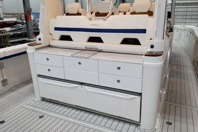Slide: The Image of 2026 Formula 457 Center Console Fish boat interior with seating and storage drawers. - 20