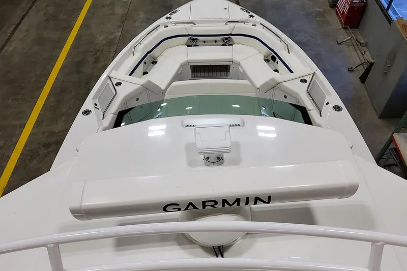 Slide: The Image of 2026 Formula 457 Center Console Fish boat with Garmin equipment, viewed from above in a workshop. - 26