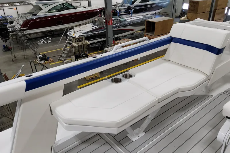 Slide: The Image of 2026 Formula 457 Center Console Fish boat interior with white seating and cup holders. - 27