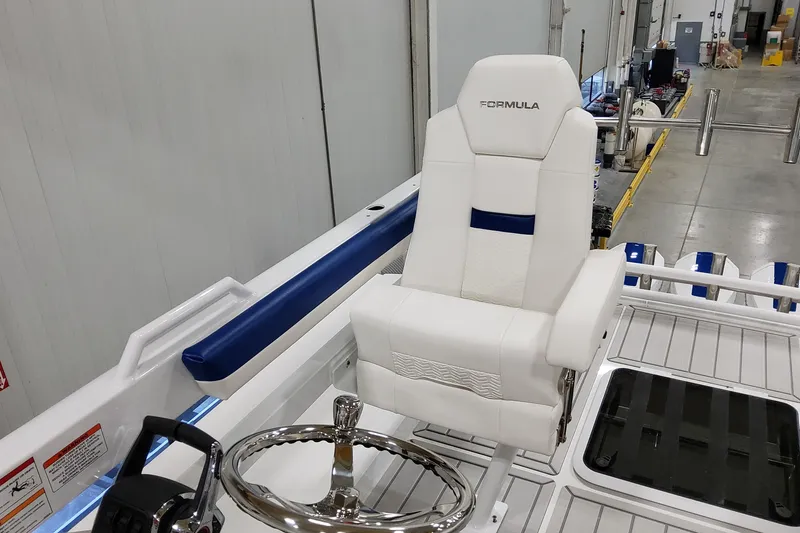Slide: The Image of 2026 Formula 457 Center Console Fish boat helm with white captain's chair and steering wheel. - 28