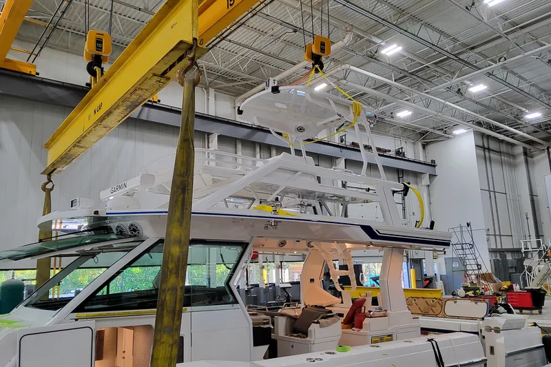 Slide: The Image of 2026 Formula 457 Center Console Fish boat assembly in a factory setting. - 3
