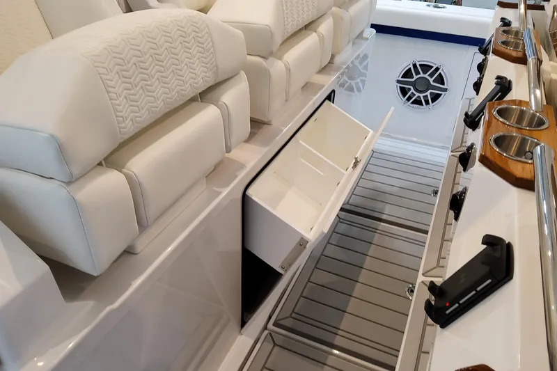 Slide: The Image of 2026 Formula 457 Center Console Fish boat interior with white seating and storage compartment. - 40