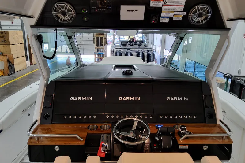 Slide: The Image of 2026 Formula 457 Center Console Fish boat dashboard with Garmin displays and Mercury controls. - 44