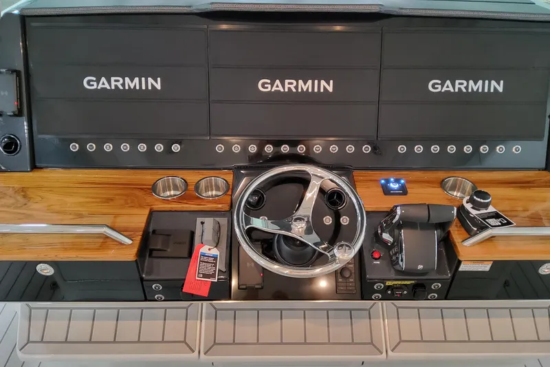 Slide: The Image of 2026 Formula 457 Center Console Fish dashboard with Garmin displays and steering wheel. - 45