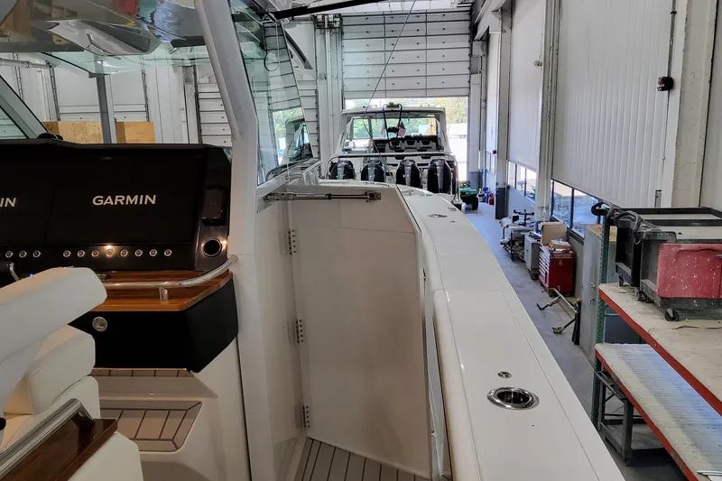 Slide: The Image of 2026 Formula 457 Center Console Fish boat in a garage with Garmin equipment. - 47