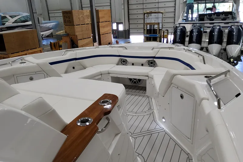 Slide: The Image of 2026 Formula 457 Center Console Fish boat interior with seating and storage in a showroom. - 51