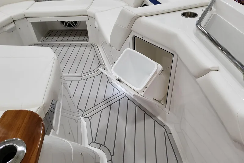Slide: The Image of 2026 Formula 457 Center Console Fish boat interior with white seating and storage compartment. - 52
