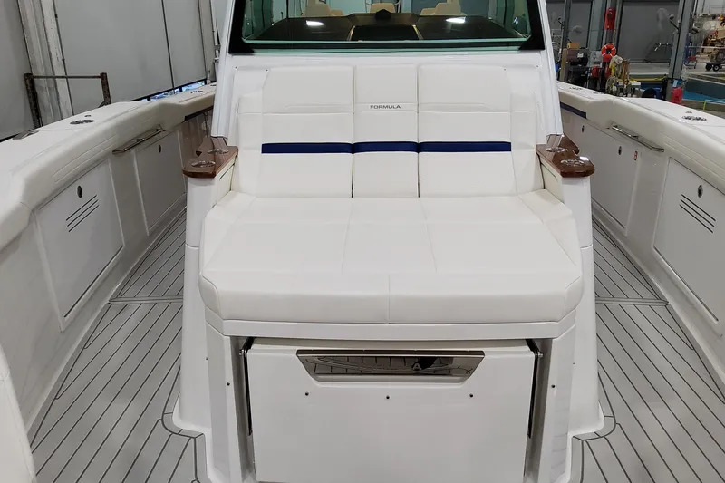 Slide: The Image of 2026 Formula 457 Center Console Fish boat interior with white seating and sleek design. - 54