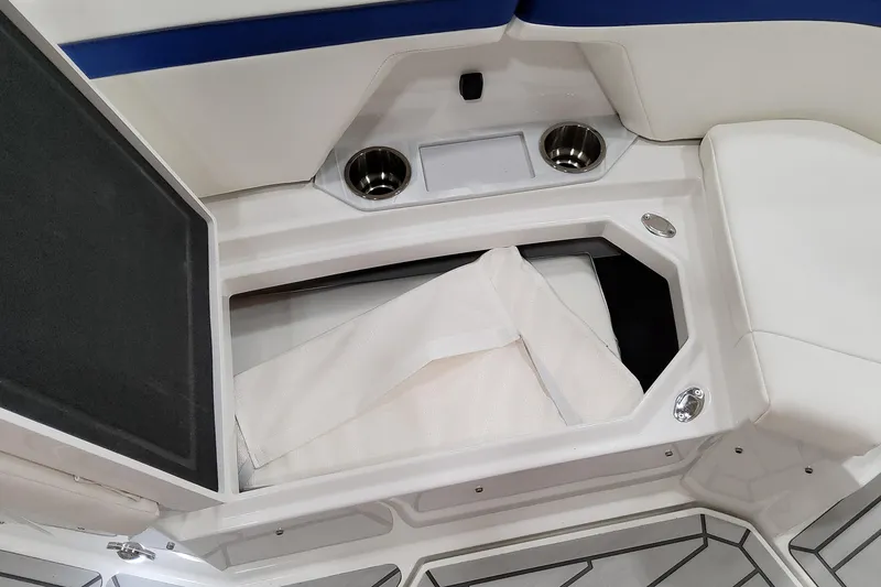 Slide: The Image of 2026 Formula 457 Center Console Fish boat interior storage compartment with cup holders. - 61