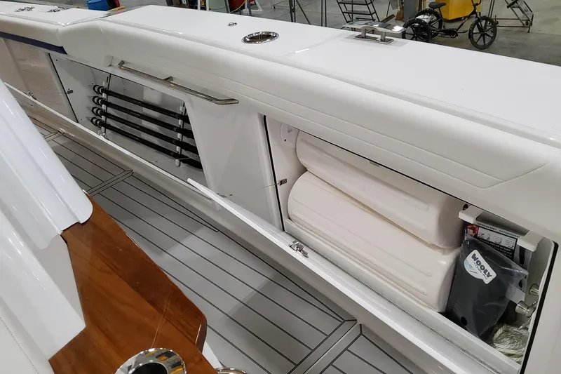 Slide: The Image of 2026 Formula 457 Center Console Fish boat interior with storage compartments and fishing rod holders. - 64