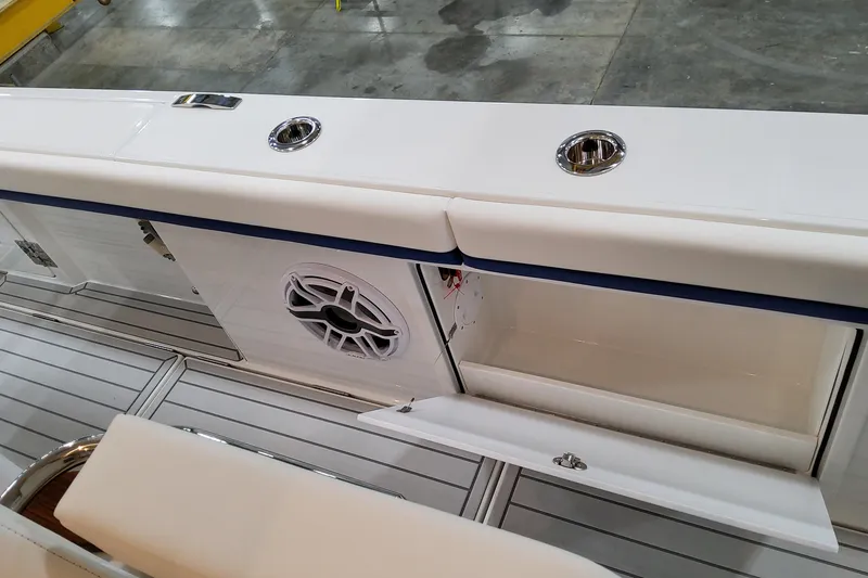 Slide: The Image of 2026 Formula 457 Center Console Fish boat interior with storage and speaker detail. - 65