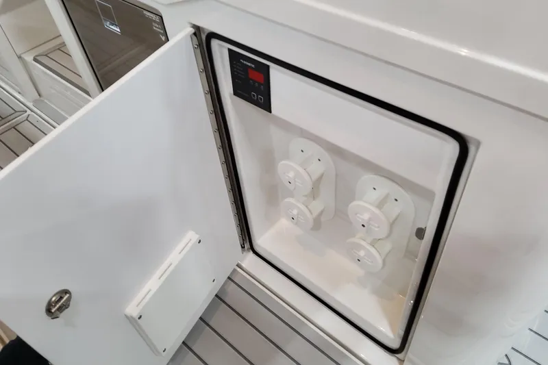 Slide: The Image of Open compartment on 2026 Formula 457 Center Console Fish boat, showing electrical panel. - 67