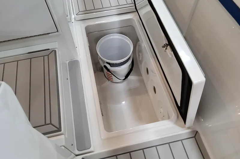 Slide: The Image of 2026 Formula 457 Center Console Fish boat storage compartment with bucket. - 69