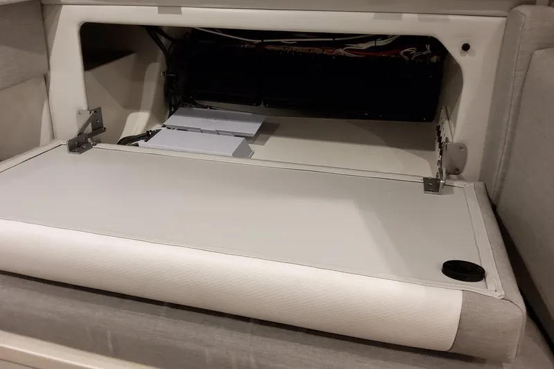 Slide: The Image of 2026 Formula 457 Center Console Fish interior storage compartment with open hatch. - 72