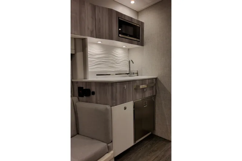 Slide: The Image of Modern kitchenette in 2026 Formula 457 Center Console Fish boat, featuring sleek cabinetry and appliances. - 78