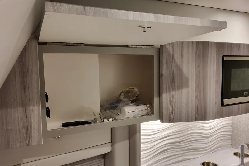 Slide: The Image of Open cabinet in 2026 Formula 457 Center Console Fish boat interior, featuring modern wood finish. - 79