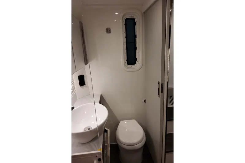 Slide: The Image of 2026 Formula 457 Center Console Fish boat bathroom with modern sink and toilet. - 83