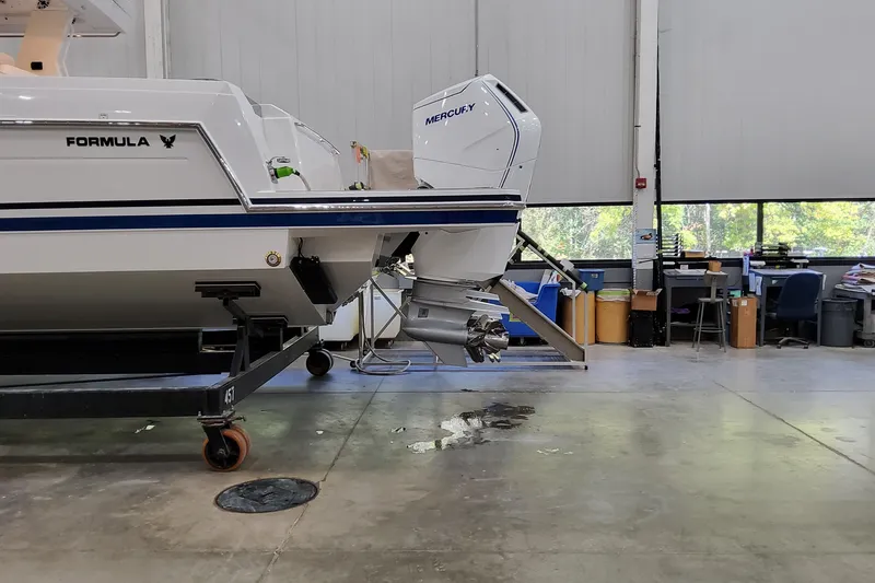 Slide: The Image of 2026 Formula 457 Center Console Fish boat in a workshop with Mercury outboard motor. - 90