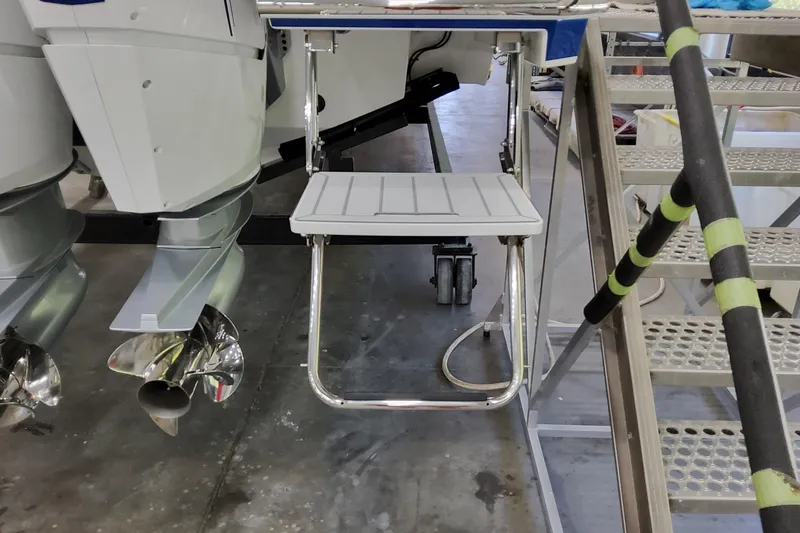 Slide: The Image of 2026 Formula 457 Center Console Fish boat with ladder and outboard motors in a workshop. - 91