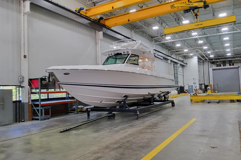 Slide: The Image of 2026 Formula 457 Center Console Fish boat in a spacious indoor facility. - 93