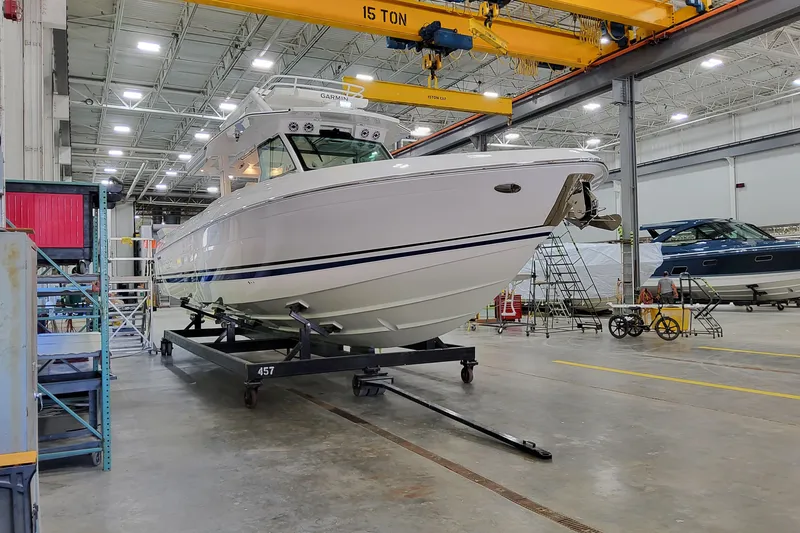 Slide: The Image of 2026 Formula 457 Center Console Fish boat in a spacious indoor facility. - 94