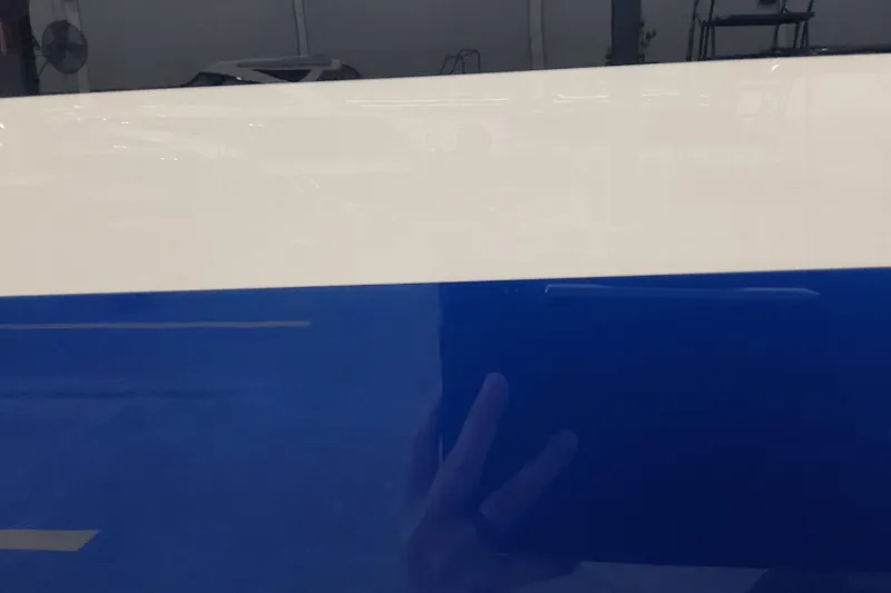 Slide: The Image of 2026 Formula 457 Center Console Fish boat with sleek blue and white hull design. - 95