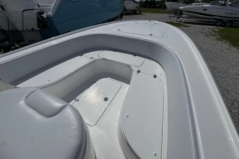 Slide: The Image of 2026 Contender 26 Bay boat interior with sleek white seating and storage compartments. - 14