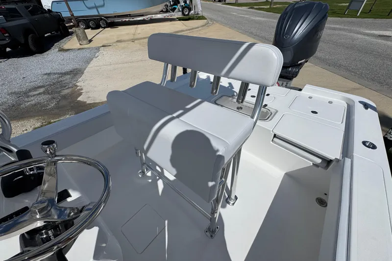 Slide: The Image of 2026 Contender 26 Bay boat interior with steering wheel and seating. - 22