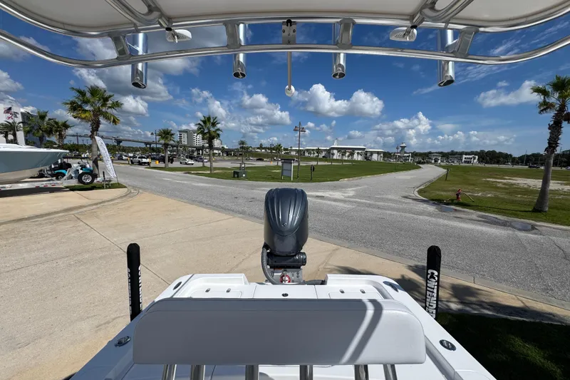 Slide: The Image of 2026 Contender 26 Bay boat at marina, clear sky, palm trees, and road view. - 24