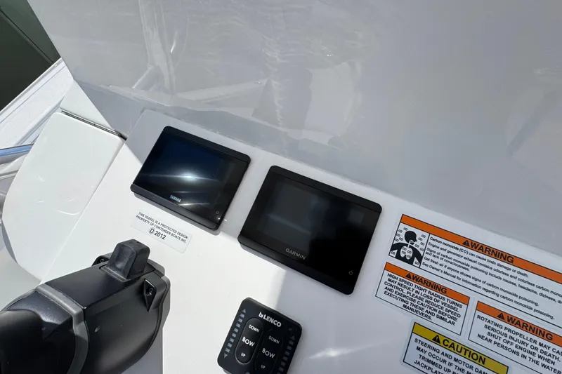 Slide: The Image of 2026 Contender 26 Bay dashboard with Yamaha and Garmin displays, warning labels visible. - 28