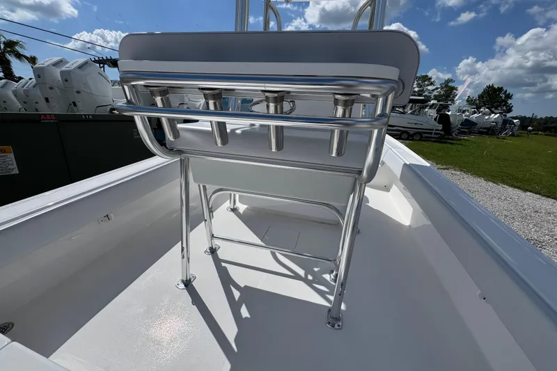 Slide: The Image of 2026 Contender 26 Bay boat interior with rod holders and seating under a sunny sky. - 31