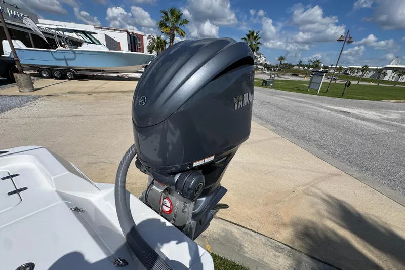 Slide: The Image of 2026 Contender 26 Bay boat with Yamaha outboard motor in a sunny marina setting. - 35