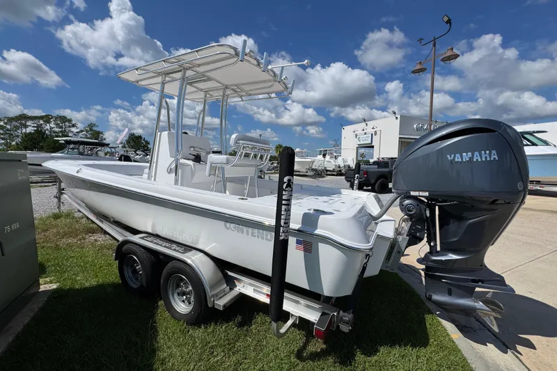 Slide: The Image of 2026 Contender 26 Bay boat with Yamaha engine on trailer, under a clear blue sky. - 8