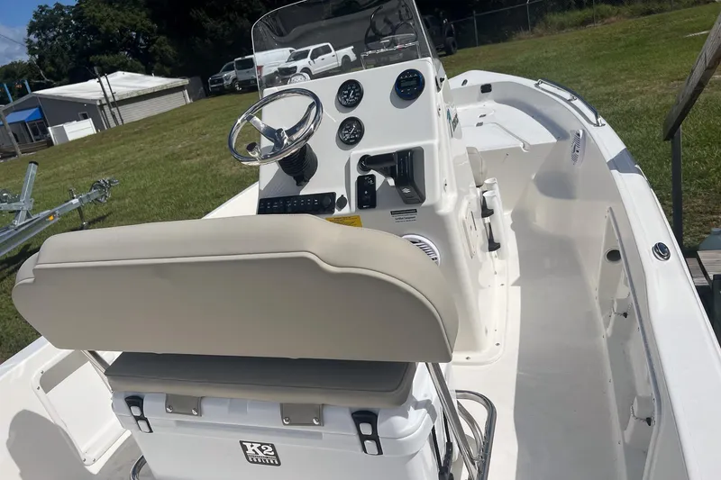 Slide: The Image of 2026 Key West 1720 Center Console boat with steering wheel and control panel, parked on grass. - 15