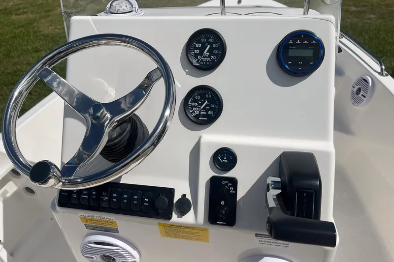 Slide: The Image of 2026 Key West 1720 Center Console boat dashboard with steering wheel and gauges. - 16