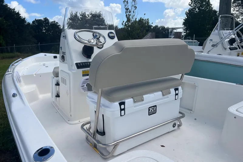 Slide: The Image of 2026 Key West 1720 Center Console boat interior with steering wheel and seating. - 4