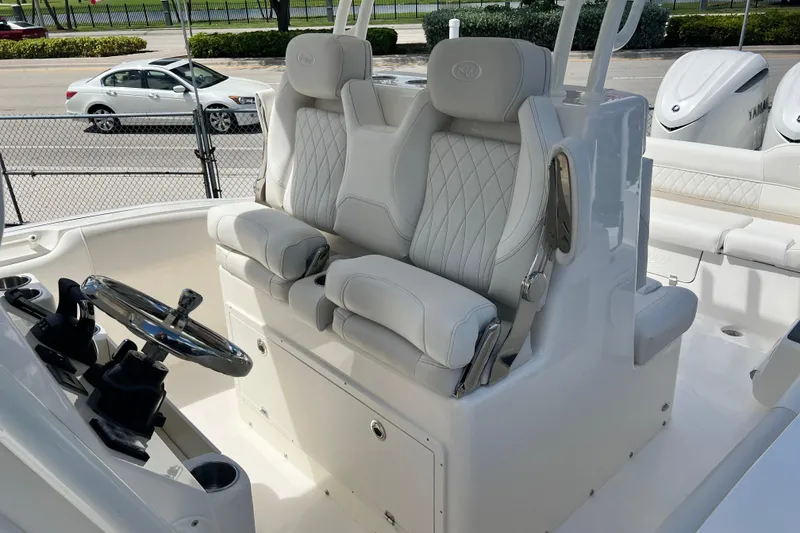 Slide: The Image of 2026 Key West 291 FS boat interior with luxurious white seating and steering console. - 15
