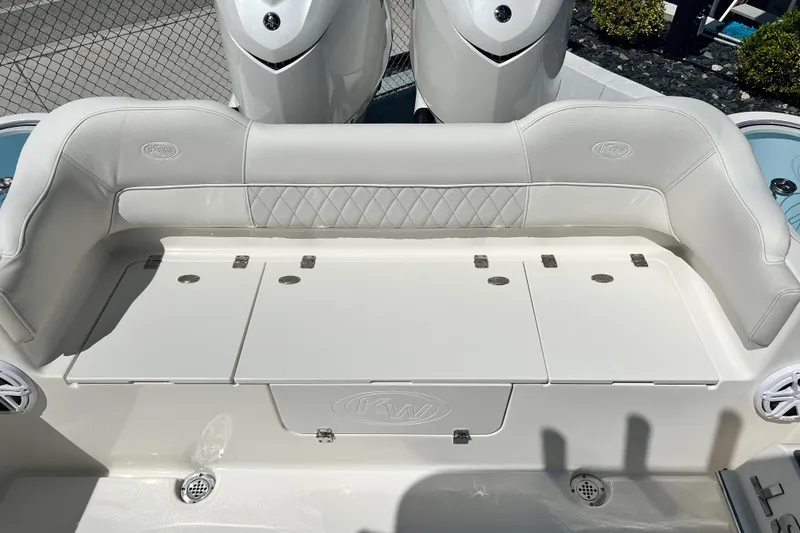 Slide: The Image of 2026 Key West 291 FS boat seating with storage compartments and dual engines. - 19