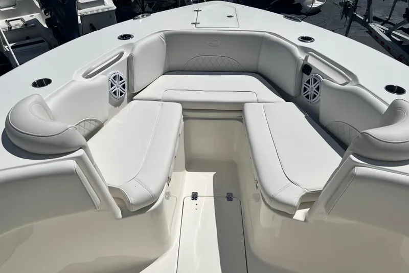 Slide: The Image of 2026 Key West 291 FS boat interior with white cushioned seating and built-in speakers. - 26