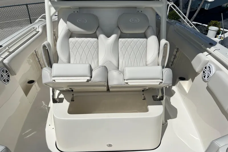 Slide: The Image of 2026 Key West 291 FS boat with luxurious white seating and storage compartment. - 32