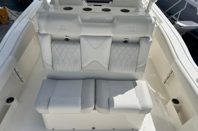 Slide: The Image of 2026 Key West 291 FS boat interior with white cushioned seating and cup holders. - 33