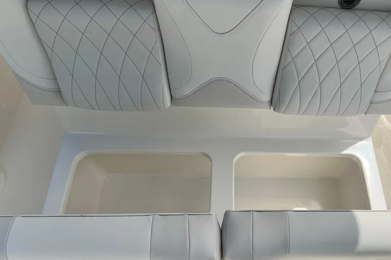 Slide: The Image of 2026 Key West 291 FS boat seating with storage compartments, featuring quilted upholstery. - 34
