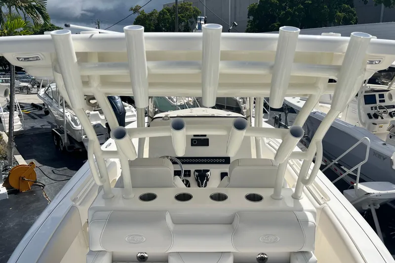 Slide: The Image of 2026 Key West 291 FS boat interior with rod holders and seating, docked outdoors. - 38