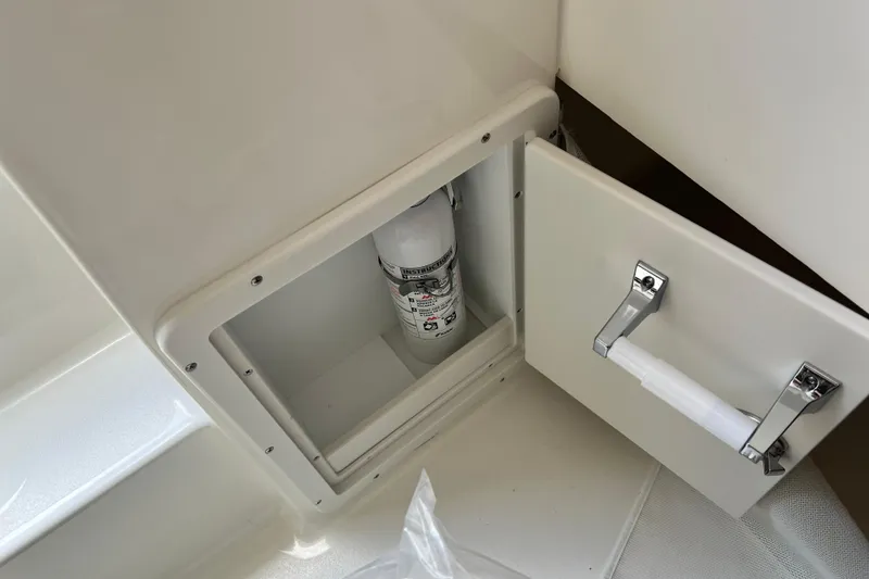 Slide: The Image of Storage compartment with fire extinguisher on 2026 Key West 291 FS boat. - 51