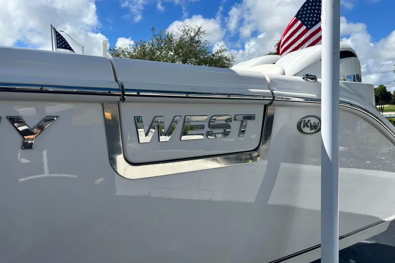 Slide: The Image of 2026 Key West 291 FS boat with American flag, shiny chrome lettering. - 9