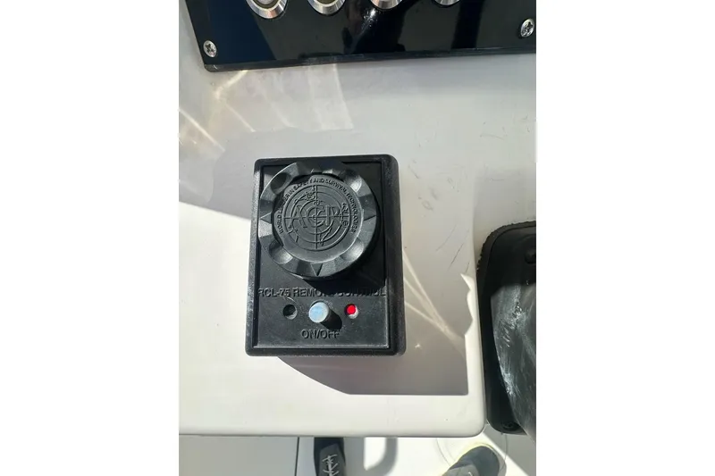 Slide: The Image of Control panel on a 2015 Edgewater 320CC boat dashboard. - 11