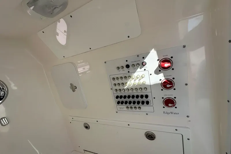 Slide: The Image of Control panel of a 2015 Edgewater 320CC boat with switches and dials. - 15