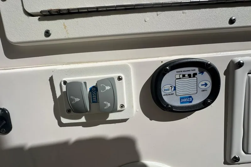 Slide: The Image of Control panel on 2015 Edgewater 320CC boat featuring Jabsco waste tank indicators. - 16