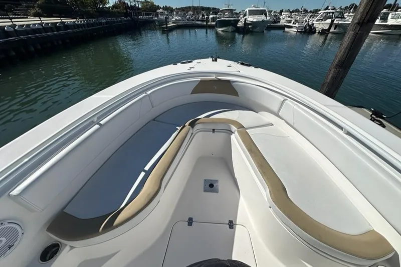 Slide: The Image of 2015 Edgewater 320CC boat interior with spacious seating at marina. - 18